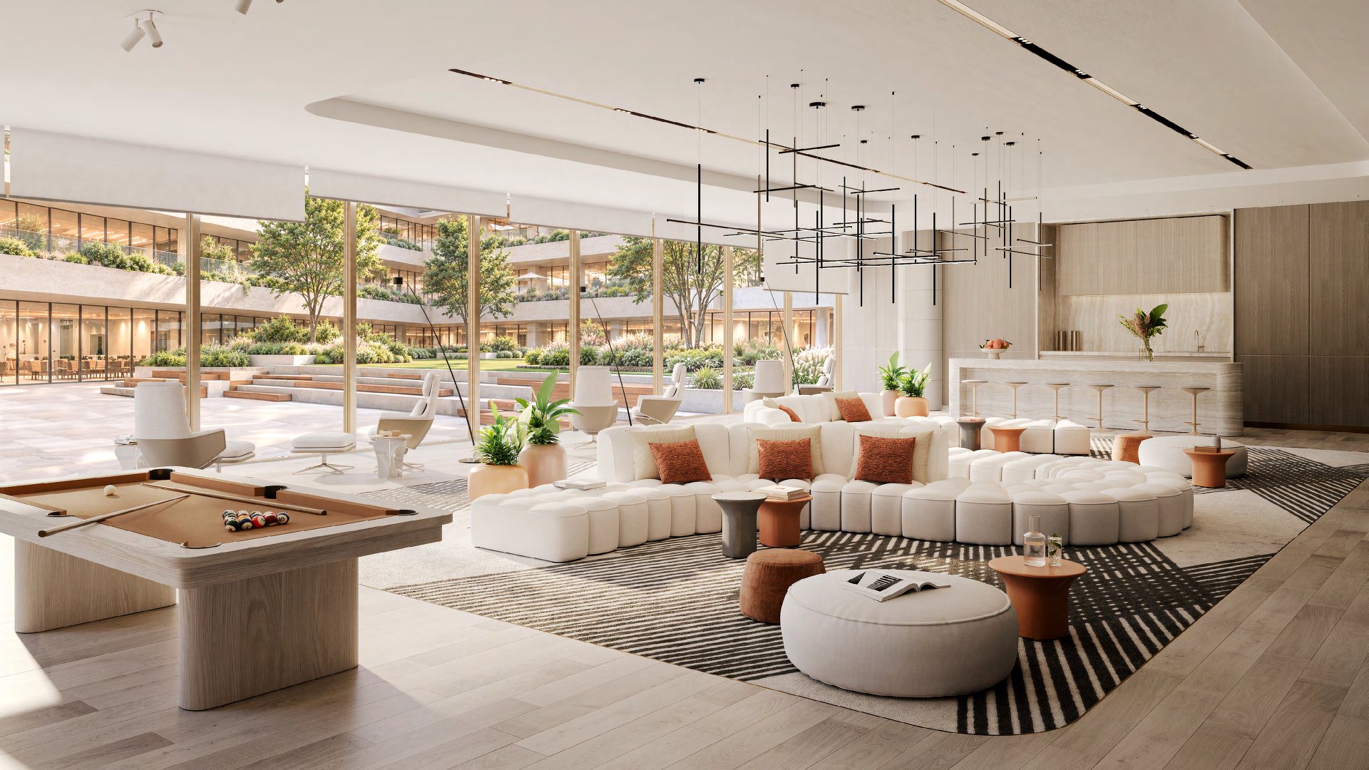Business centre lounge with curved sofa, bar counter and garden views