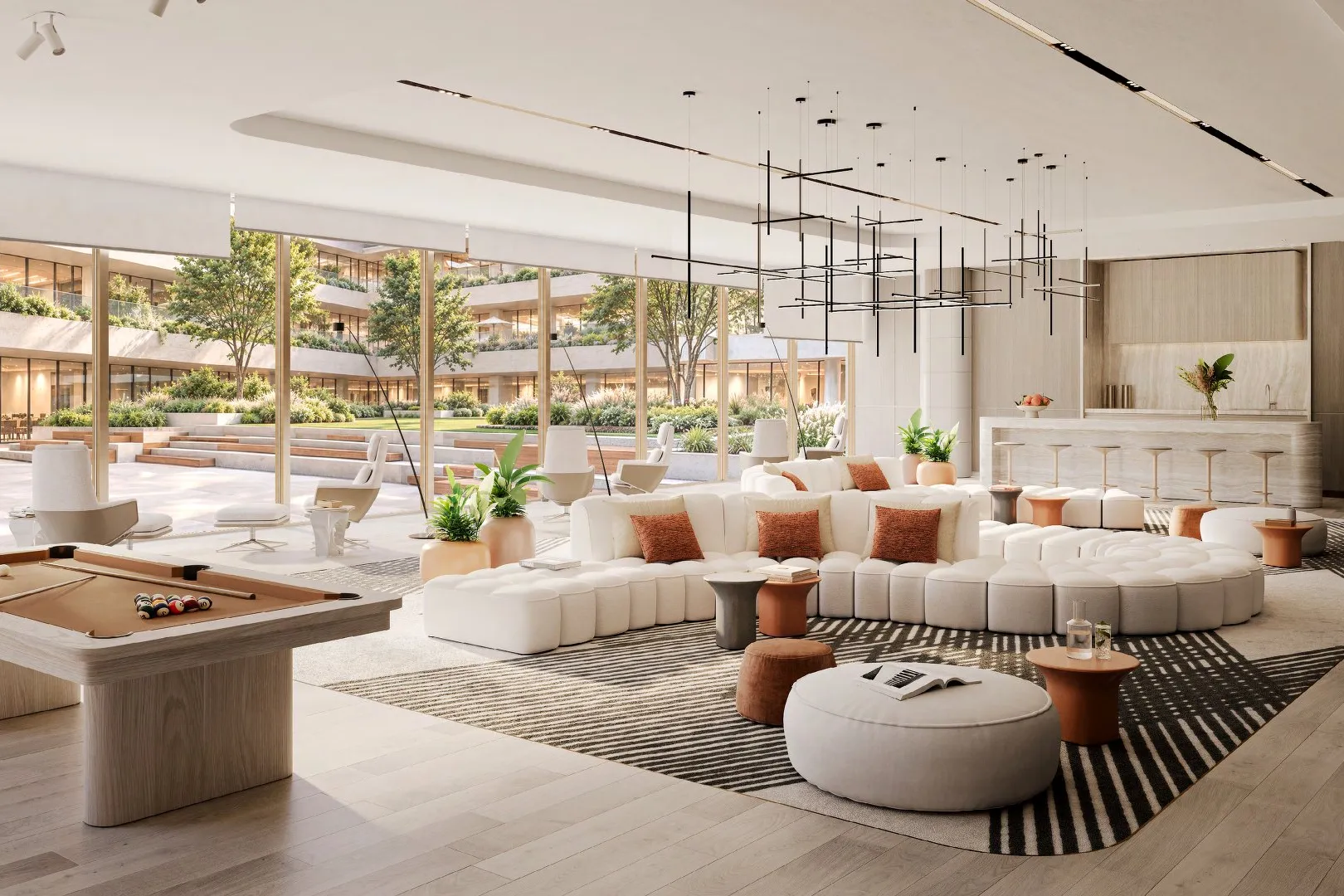 Business centre lounge with curved sofa, bar counter and garden views