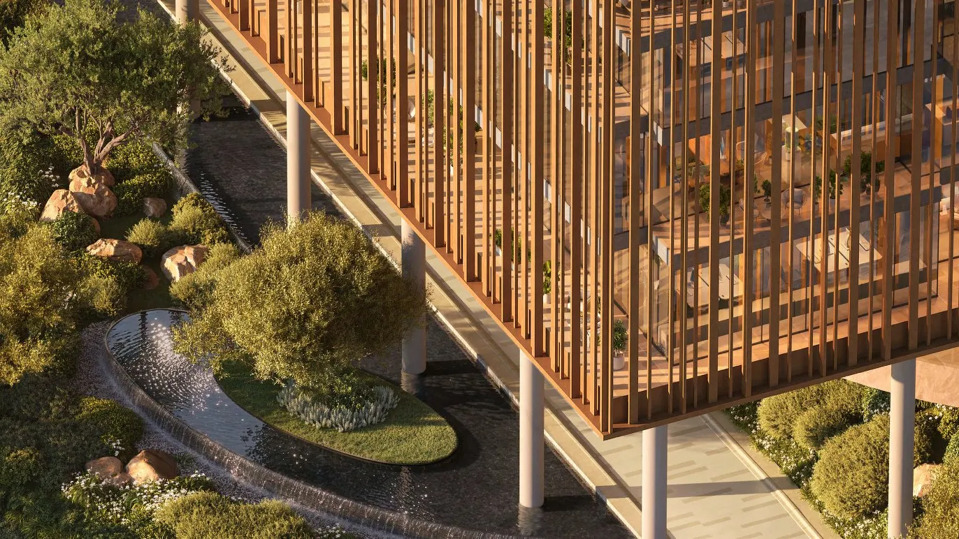 Louvred office block raised on columns over gardens and a water feature